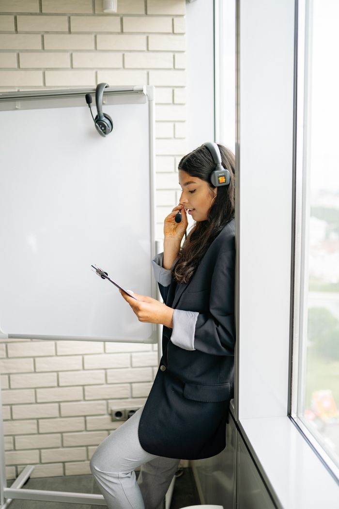 A professional call center agent with headset in a modern office environment.